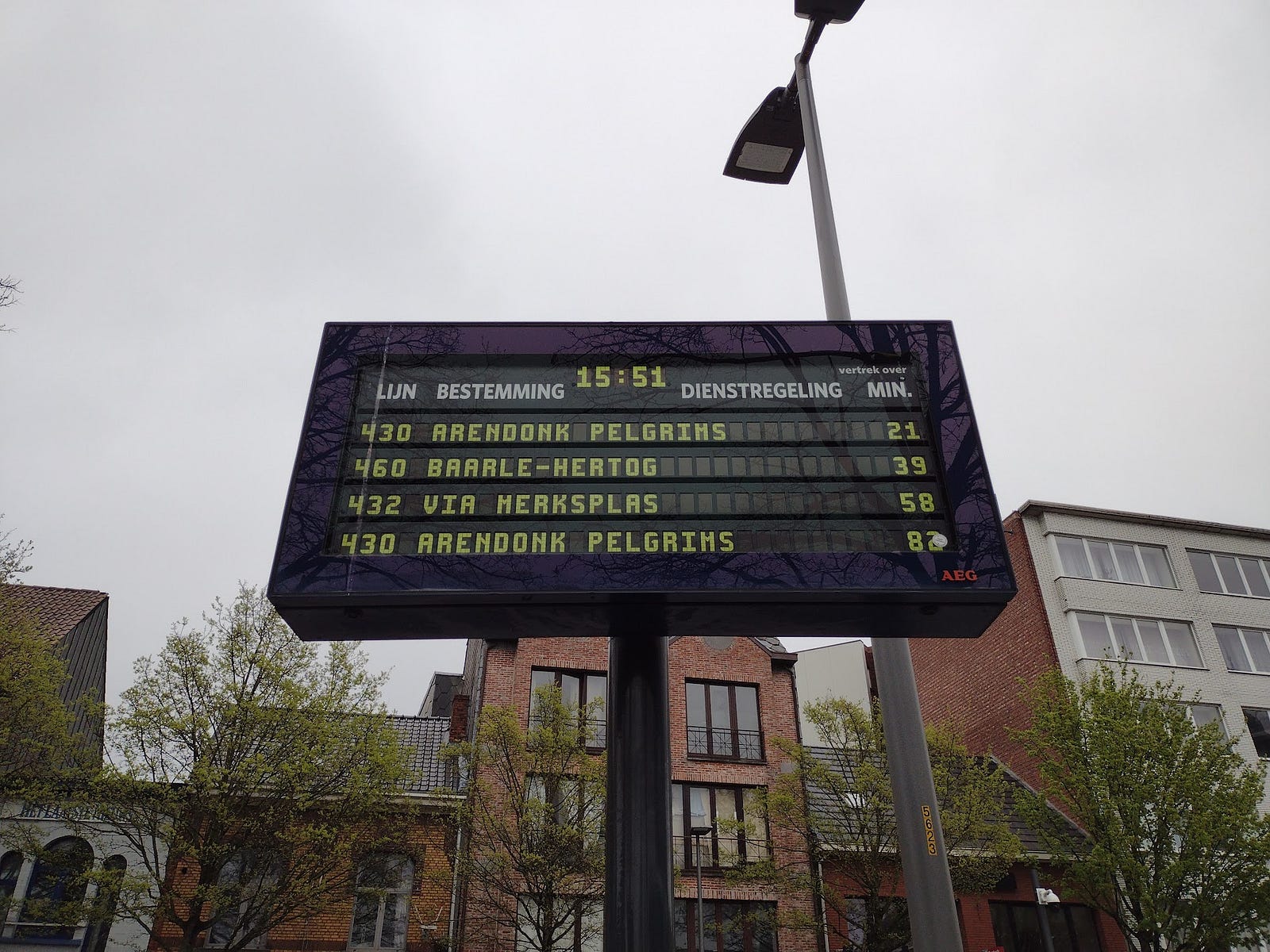 Sign showing times until buses arrive, including Baarle-Hertog